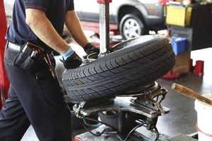 Mechanic carrying tire