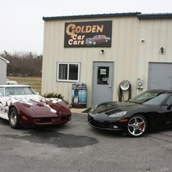 White and black chevy outside Golden Car Care shop