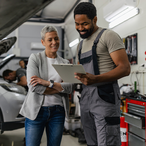 Mechanic consulting with client about car repair