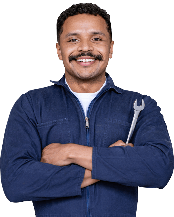 Portrait of a Latin American mechanic working at a car garage and holding a wrench while smiling